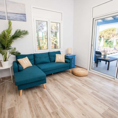 Relax on the comfortable sofa and look out onto the pool